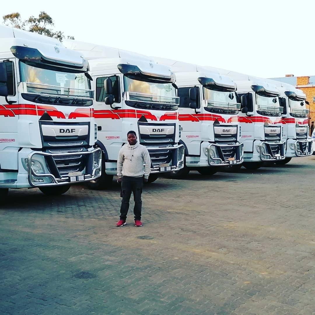 Fleet lineup of DAF commercial trucks with corporate branding